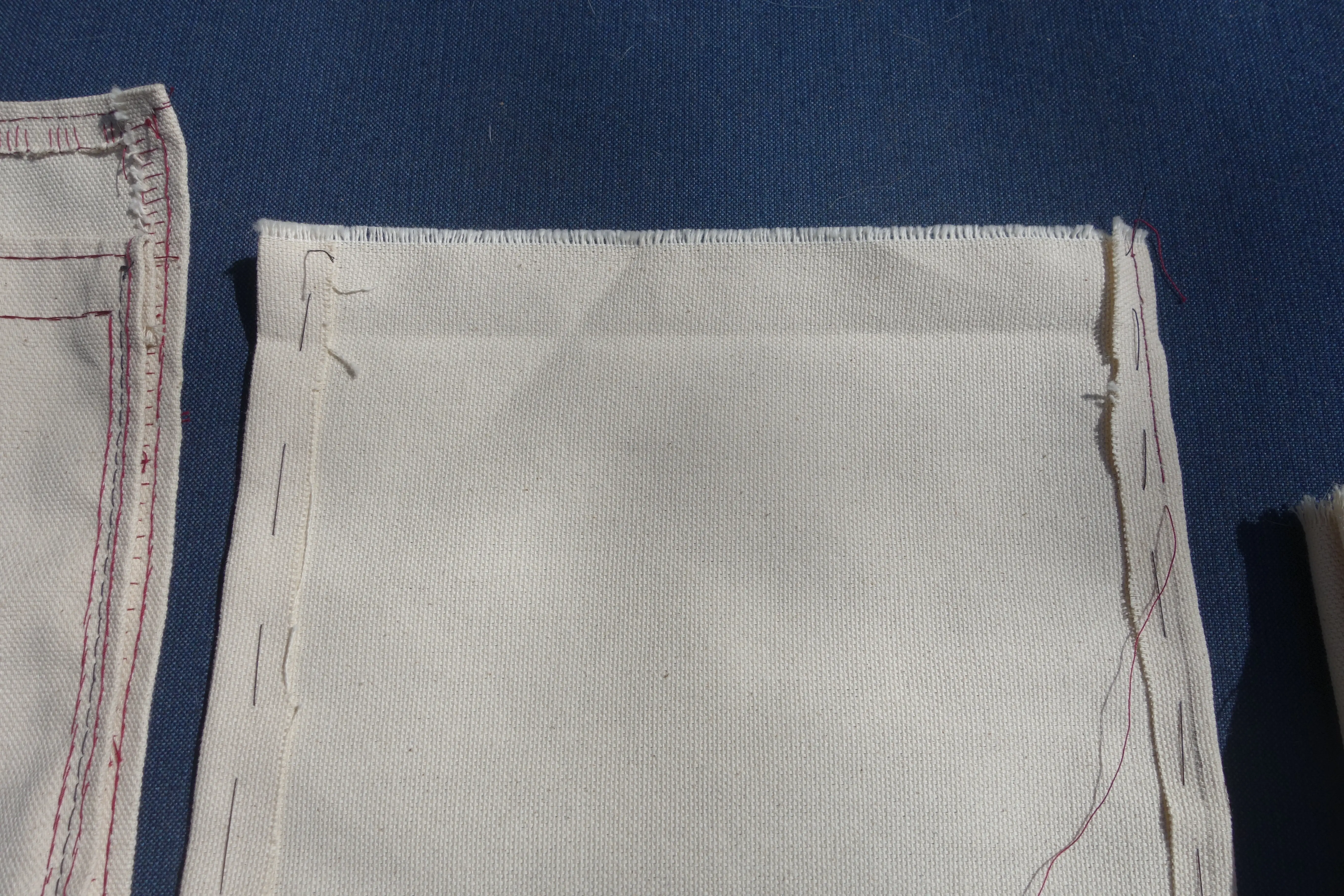 a piece of fabric with some stitching and some lines drawn on it to mark sewing lines